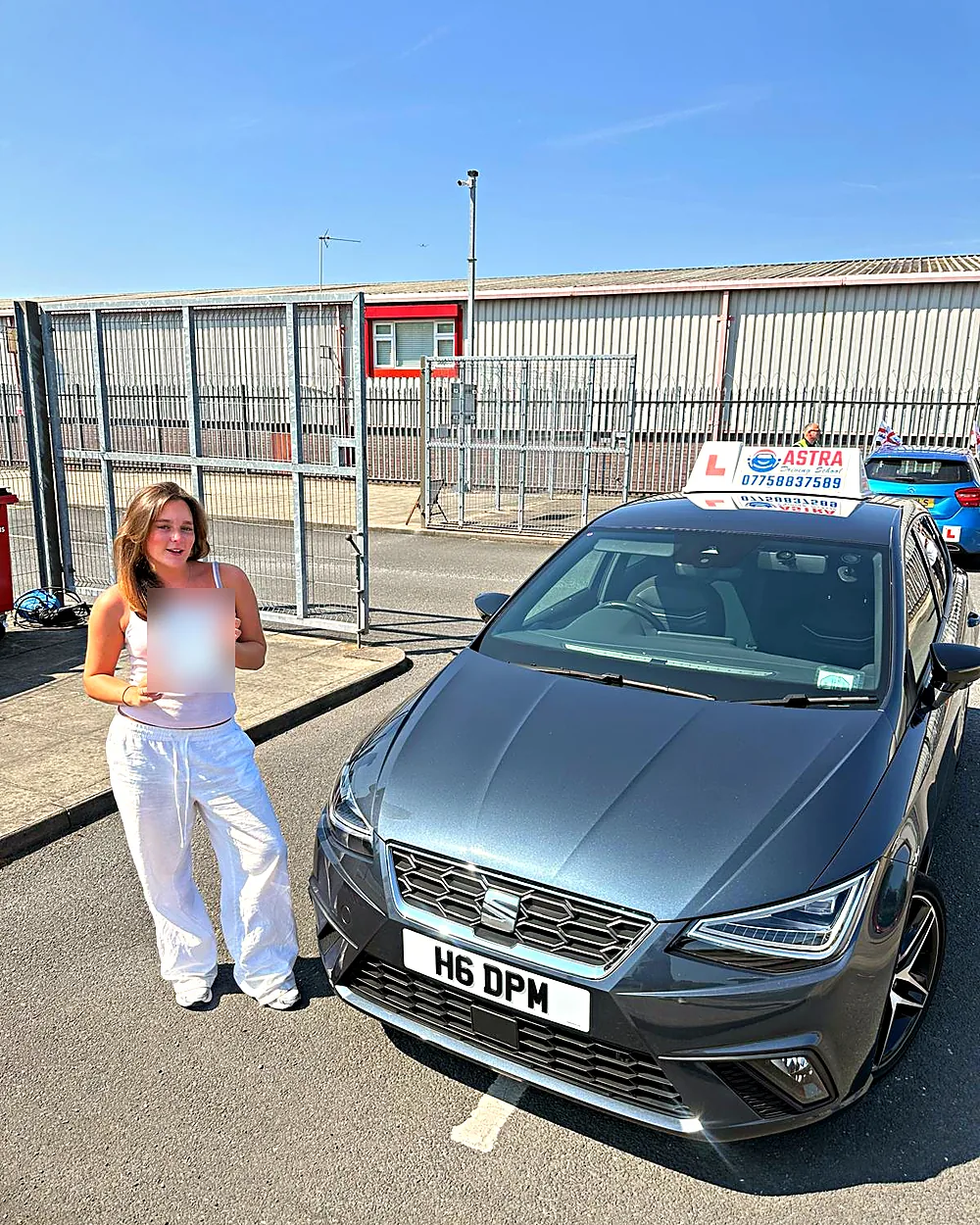 Astra Driving School student holding their driving test pass certificate