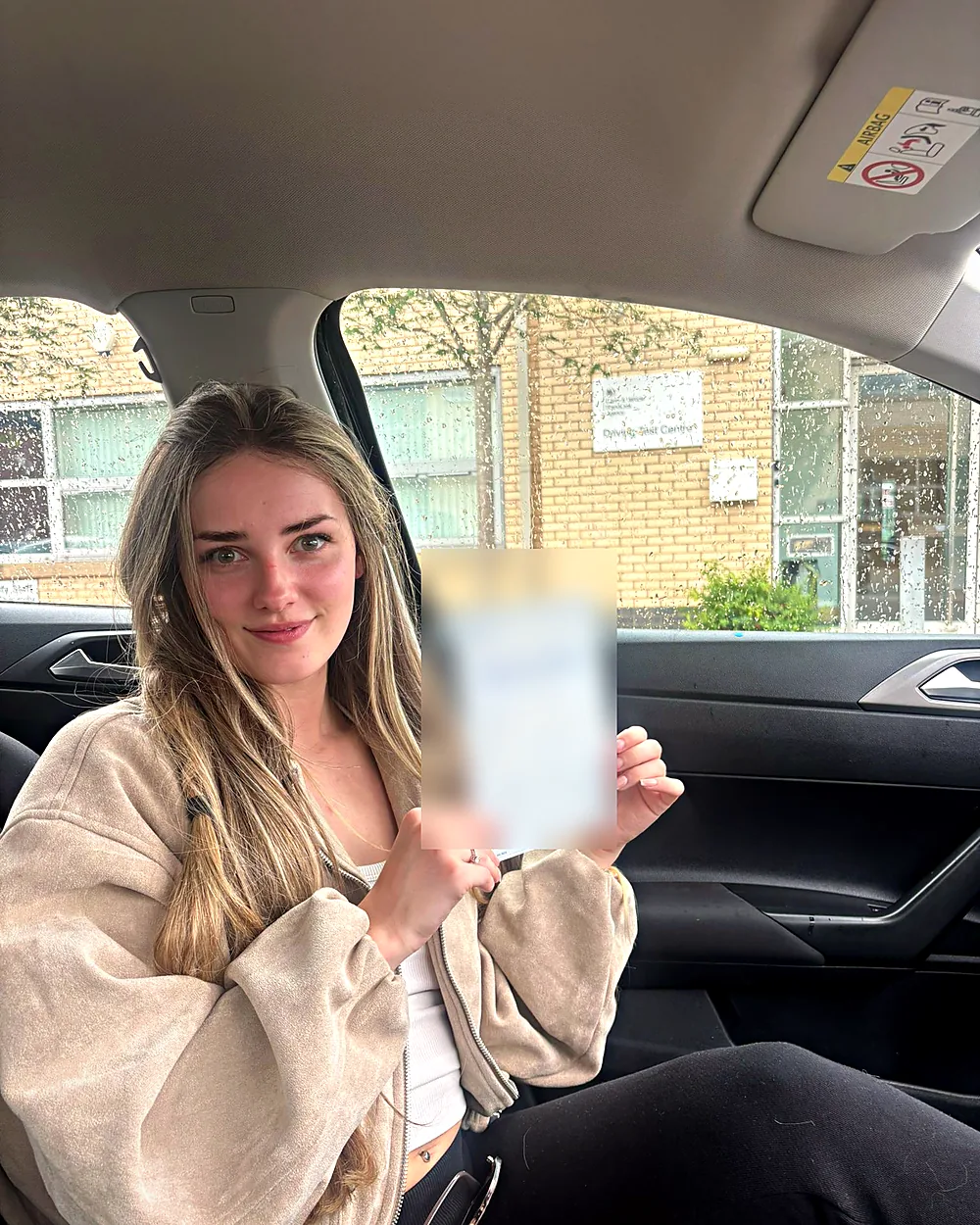 Astra Driving School student holding their driving test pass certificate